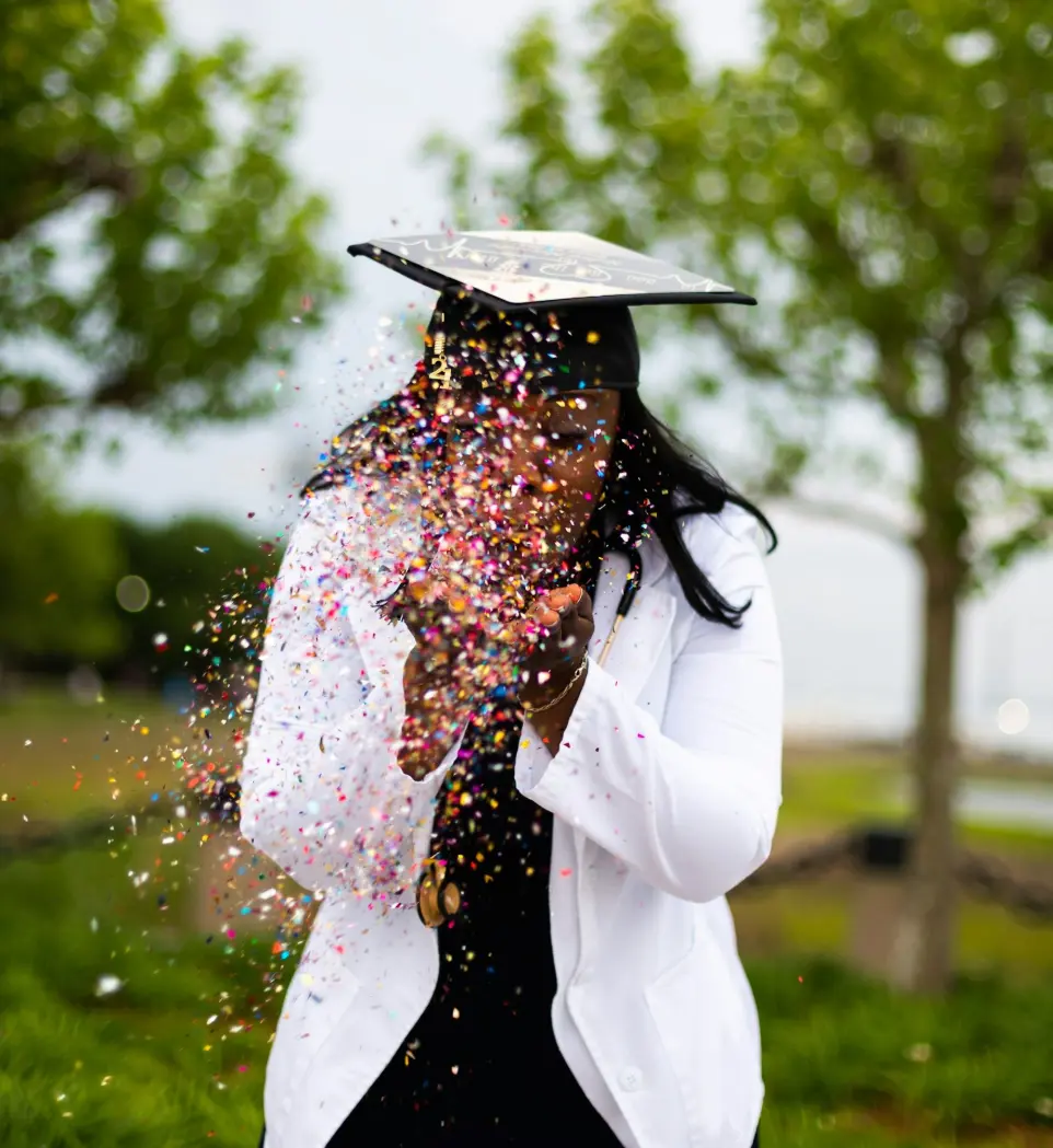 Celebrate Your Achievement with RPL | Right Pathway Australia a woman in a graduation cap throwing confetti on her face
